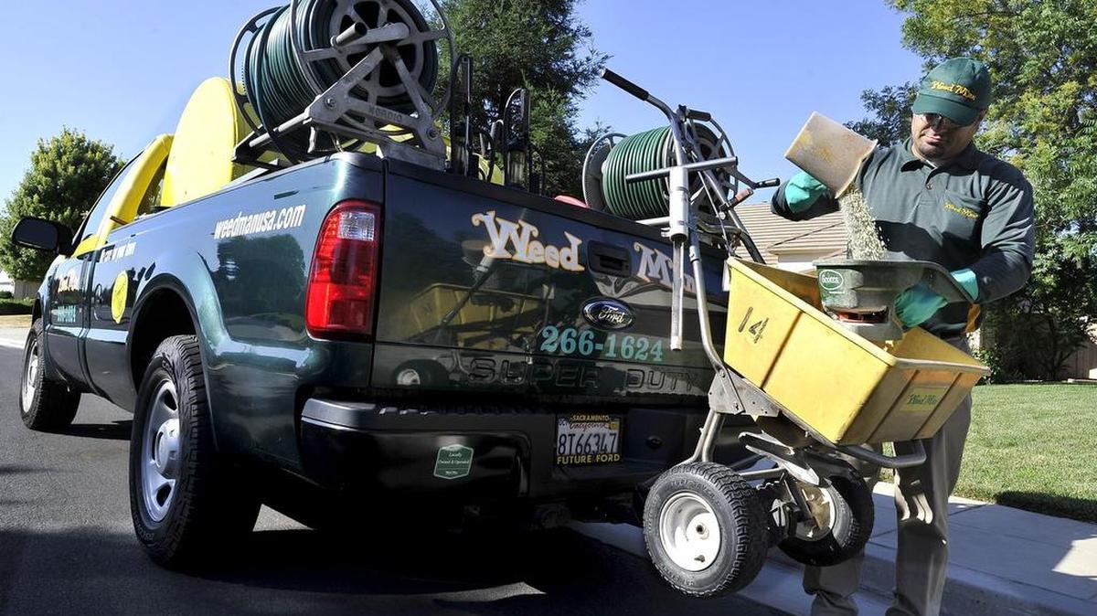 
Weed Man Lawn Care’s Justin Ramirez prepares to fertilize a client’s lawn.
