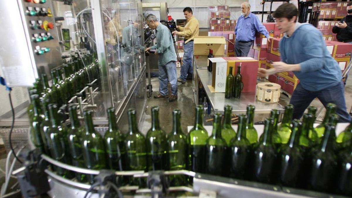 Bottles cruise through a bottling line at the Fresno State Winery in this file photo. Wines produced by students at the winery received gold, silver and bronze medals at several major wine competitions during 2015.