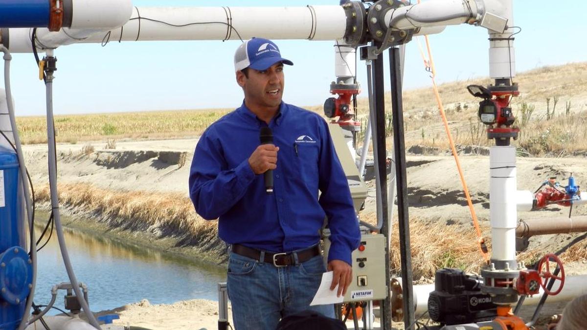 
John Cardoza, a project manager with Sustainable Conservation, talks about the use of drip irrigation in dairy feed crops during a tour of DeJager Farms, southeast of Merced, Calif., on Wednesday, Aug. 26, 2015. This group, which is based in San Francisco and has a Modesto branch office, is testing this water-saving system with NetafimUSA, which makes drip irrigation supplies and has a Fresno branch. The pipes behind Cardoza are part of a filtering system for manure-tainted wastewater that is mixed with fresh water and applied to feed crops.
