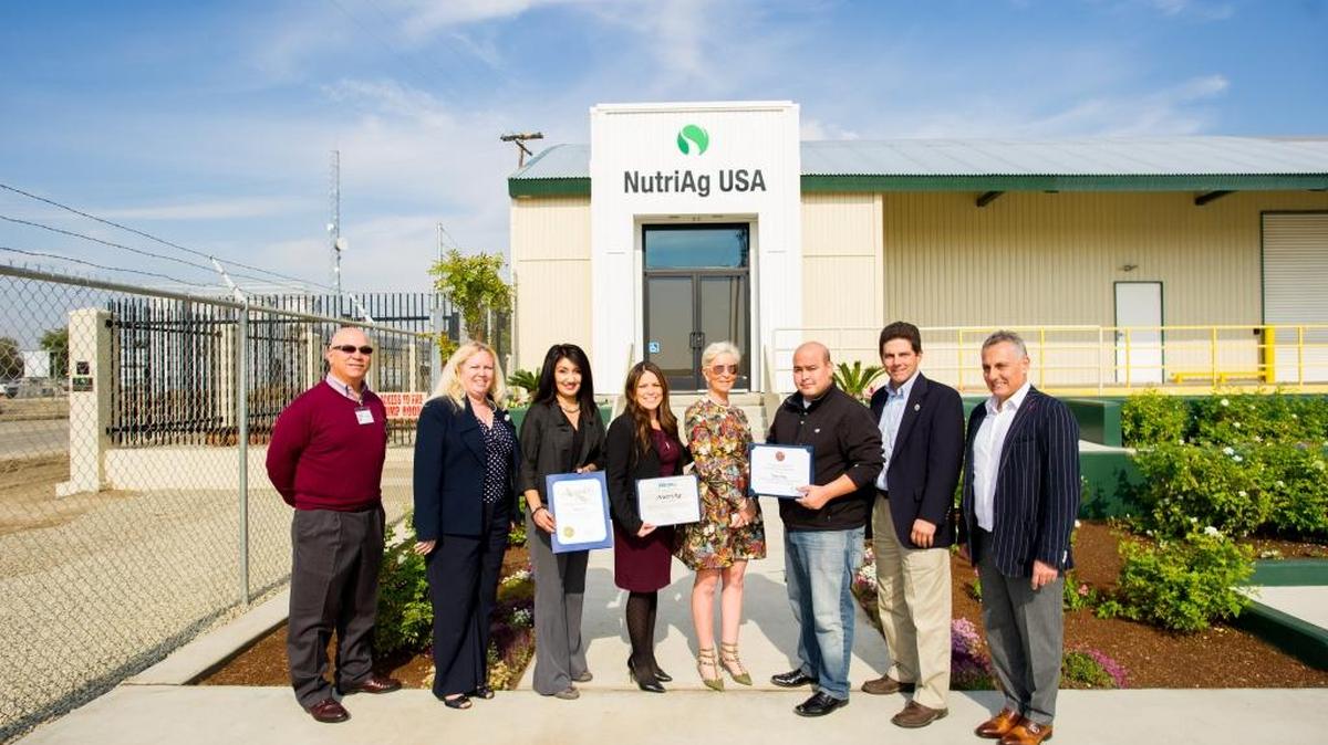 Elected officials, their representatives and company leaders celebrate the opening of the NutriAg manufacturing plant in Biola.