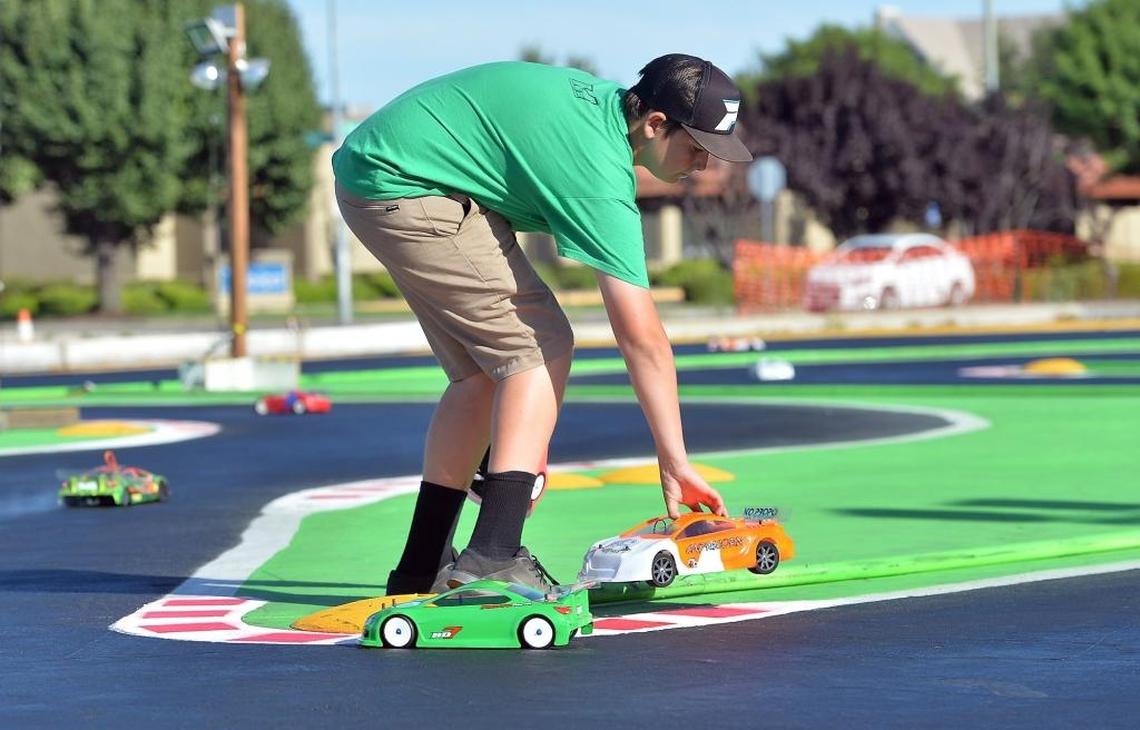 Remote-control race car hobbyist Taylor Elias of Fresno steps out onto the race track during practice at HobbyTown in Fresno in this file photo from 2016. The store has since closed.