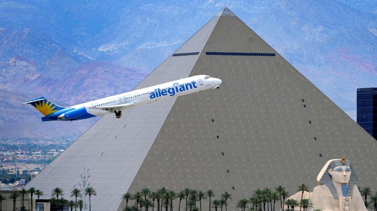 An Allegiant Air jet flies by the Luxor Resort and Casino after taking off from McCarran International Airport in Las Vegas on May 9, 2013. Allegiant flies from Fresno to Las Vegas and the Phoenix area.