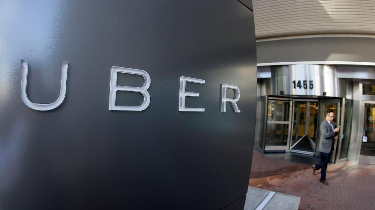 In this Dec. 16, 2014, file photo a man leaves the headquarters of Uber in San Francisco. The ride-sharing company has launched uberESPAÑOL for its Spanish-speaking riders in the Fresno area.