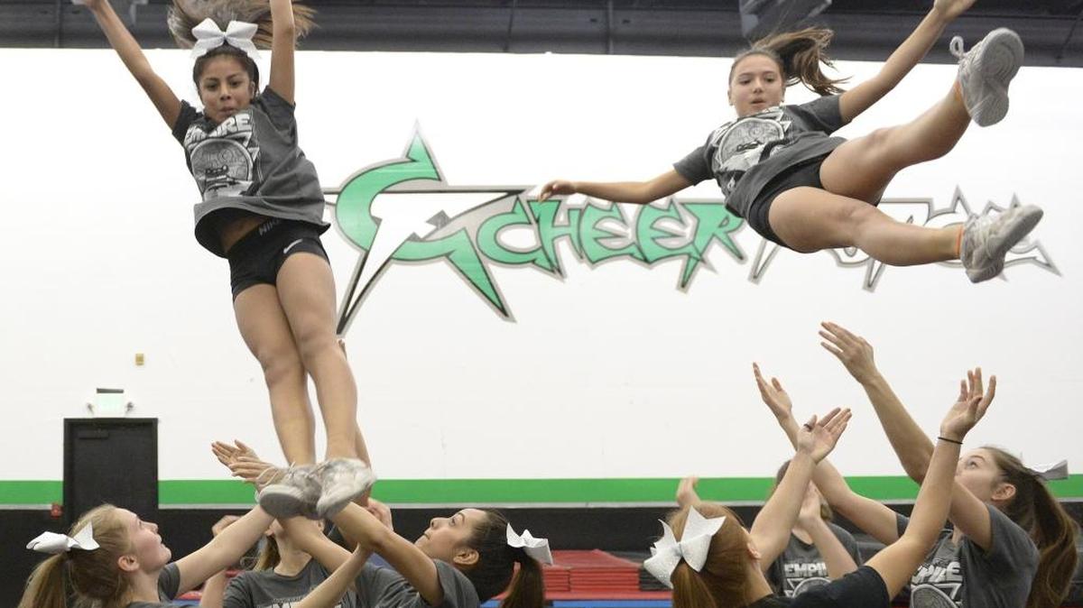 Student Rheanna Mora, left, 12, of Clovis, and Haley Boyd, 13, of Fresno perform with classmates, Sunday, Jan. 10, 2016, at Cheer Force, a cheerleading school that recently moved to Herndon and Blackstone avenues from the area of Shaw and Brawley avenues.