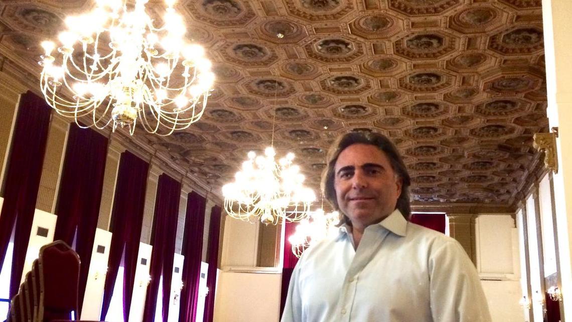
Pacific Southwest Building owner Sevak Khatchadourian stands in the building’s spruced-up Fresno Ballroom. Khatchadourian invested in new carpeting, drapes, chandeliers and modern bathrooms for the renovated ballroom. 
