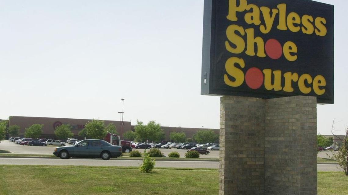 A Payless Shoe Source sign points customers to a store.