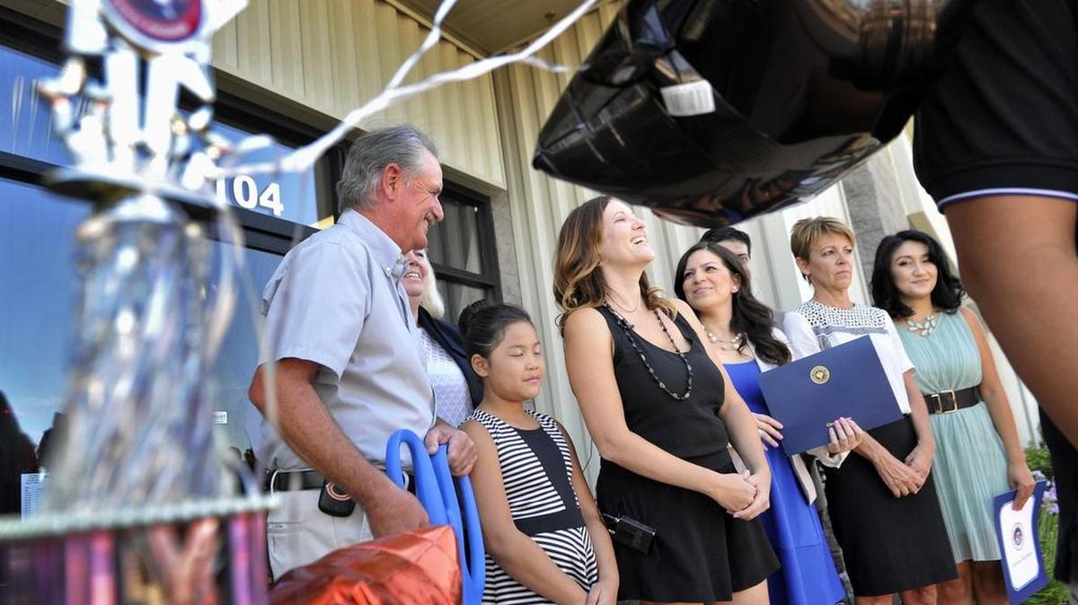 
Studio co-owner Melinda Scharnick, center, laughs as she and others prepare for the ribbon-cutting ceremony for Stars Dance Studio celebrating the opening of its new location Friday. The studio was moved due to high speed rail development.
