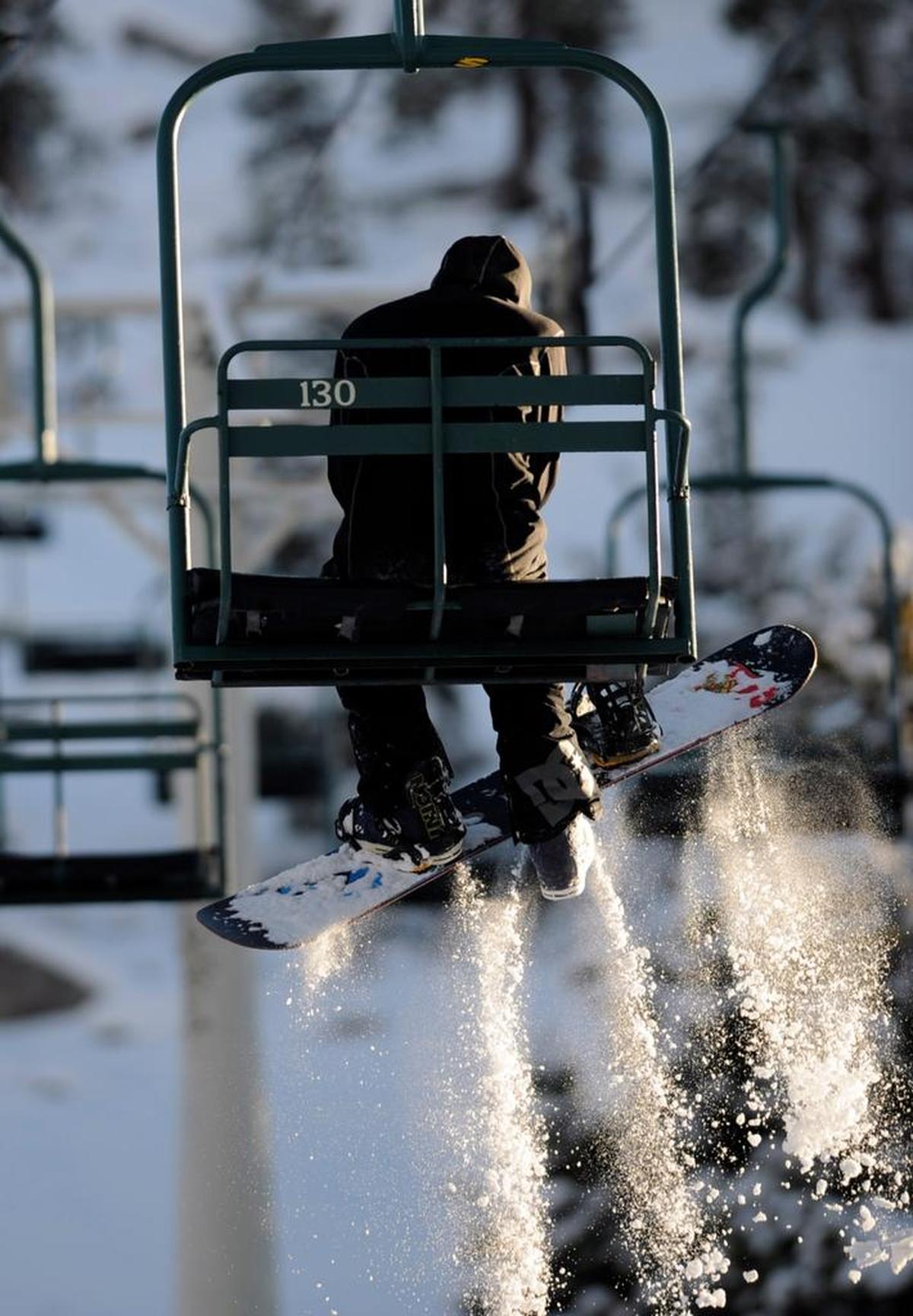 A snowboarder on a chair lift seen in this file photo of China Peak Mountain Resort. Season passes for China Peak, as well as three other small California resorts, are available for 2026-2027 through the Cali Pass.