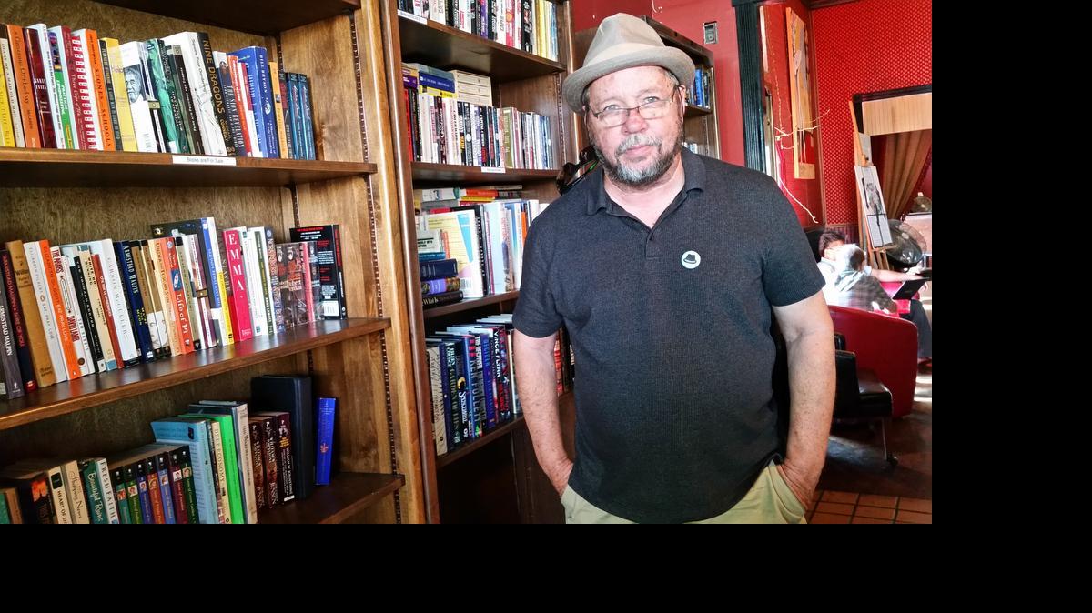 
Mark DeRaud stands with the selection of books he has to offer, from L. M. Montgomery’s classic “Anne of Green Gables” series to Robert Jordan’s contemporary “The Wheel of Time” series.
