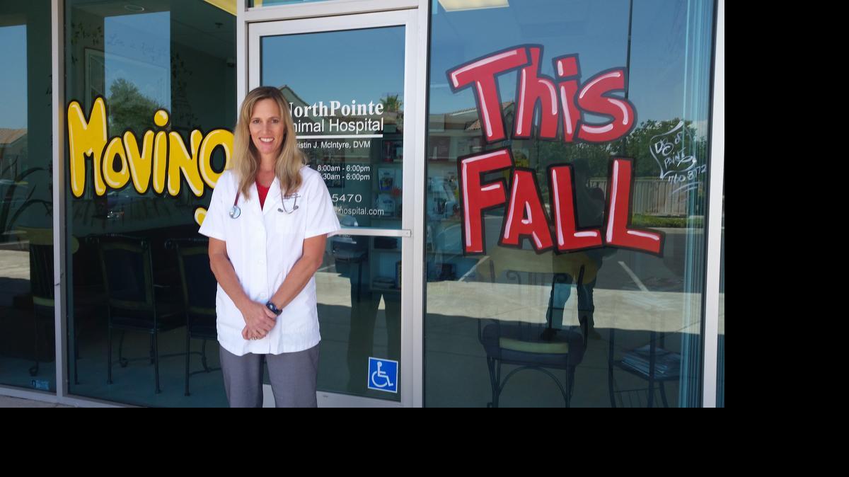 
Veterinarian Dr. Kristin J. McIntyre stands outside her clinic, where she’s advertising its relocation in fall.
