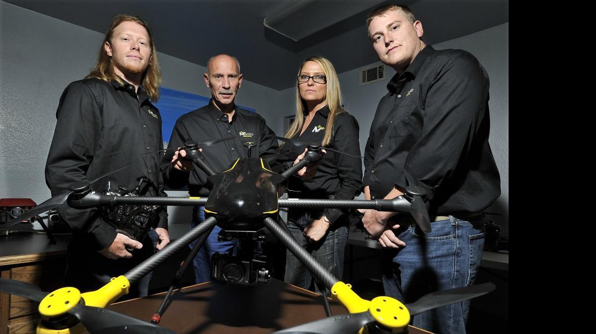 
Montico Inc., is a Fresno company that hopes to become a national leader in the use of unmanned aerial vehicles. From left, with one of the drones they use for commercial purposes: Chris Lotz, air support; company president Ron Wingo; Tracy Guerra, chief operating officer; and Chris Turner, tech adviser. 
