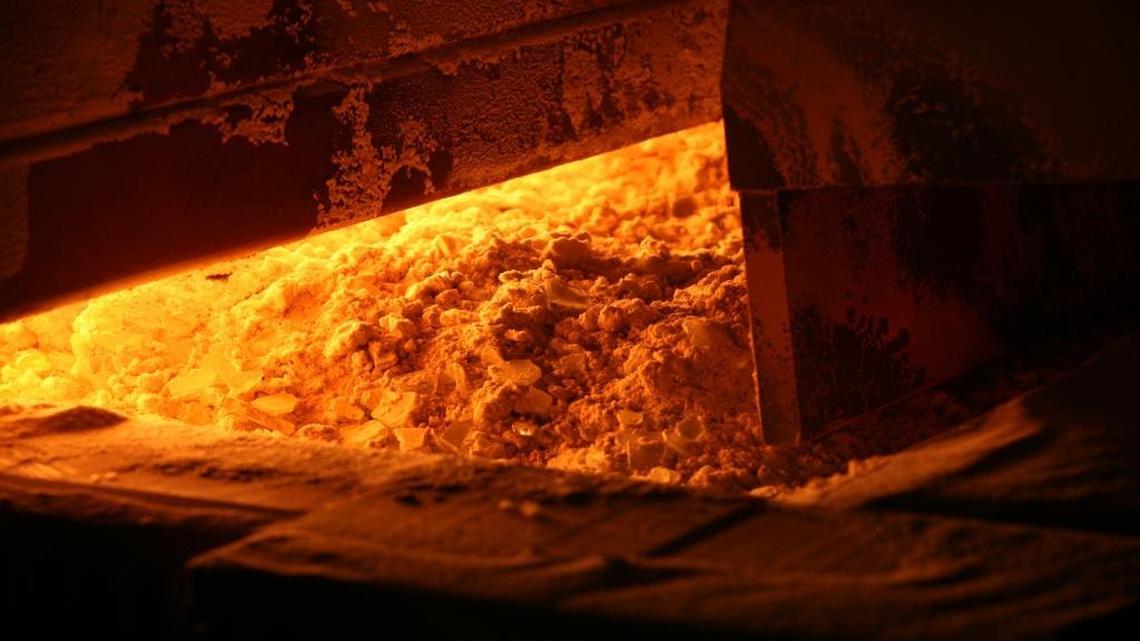
Raw materials to make glass – sand, dolomite, limestone, salt cake, charcoal, rouge and scrap glass – are pushed into the furnace at the Guardian Industries flat glass plant in Kingsburg.

