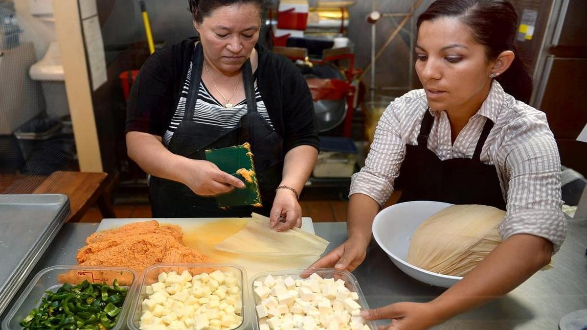 Carmen Martinez, left, and Liz Sanchez prepare tamales in the former Casa de Tamales restaurant kitchen on Shaw Avenue. Sanchez has since expanded the business to two restaurants (in the Tower District and downtown Fresno) and a food trailer, and has plans to next build a factory in downtown Fresno opening by April 2017.