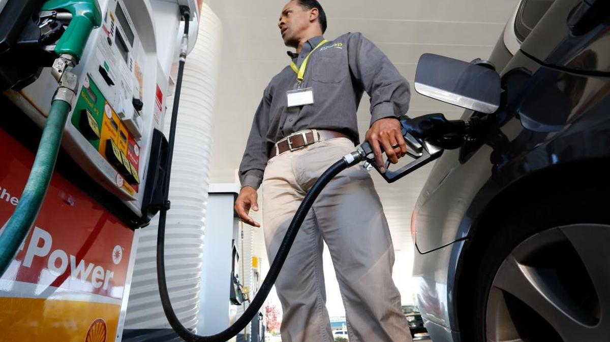In this file photo taken Friday March 7, 2014, Eric Henry gases up his car in Sacramento, Calif. Drivers in Fresno are paying an average $2.76 for a gallon of unleaded gasoline.