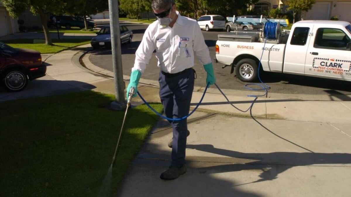 Clark Pest Control’s Ken Fish spraying pesticide.