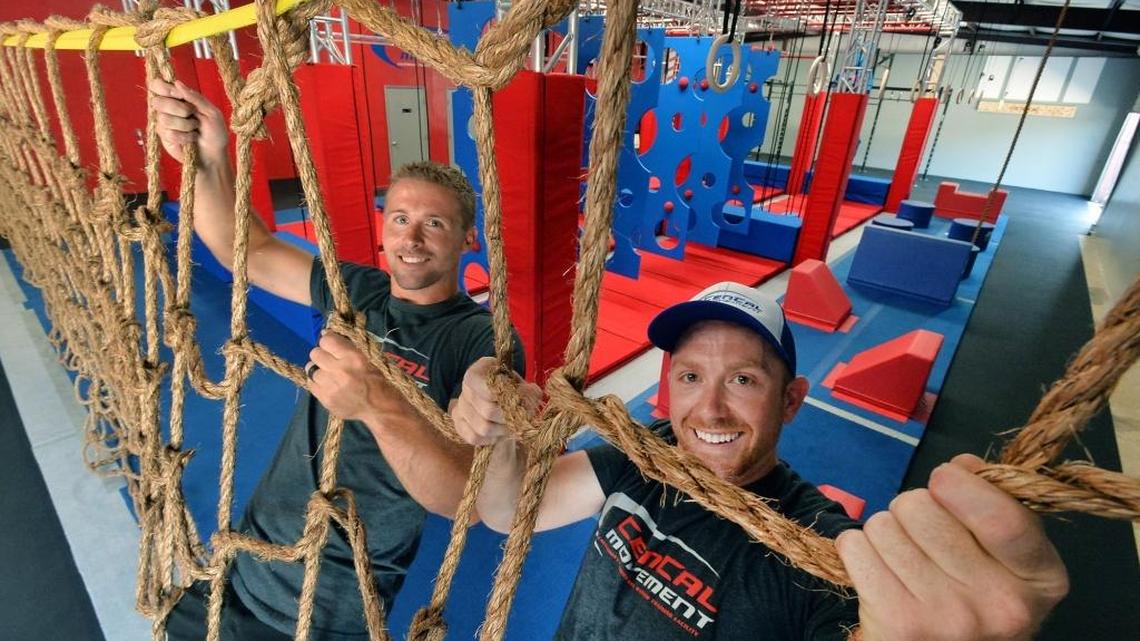 Jacob Hutchison, 29, and Tony Dawson Rabb, 29, hang on to the Lateral Cargo Net Traverse at CenCal Movement’s ninja warrior and spartan racing courses in the facility’s 5,000 square-foot facility in Visalia on Friday, July 29. The facility opens on Monday, Aug. 1, and will be open to both drop-ins and memberships seven days a week. In addition, a 4,000 square-foot outdoor training facility is being built adjacent to the indoor area.