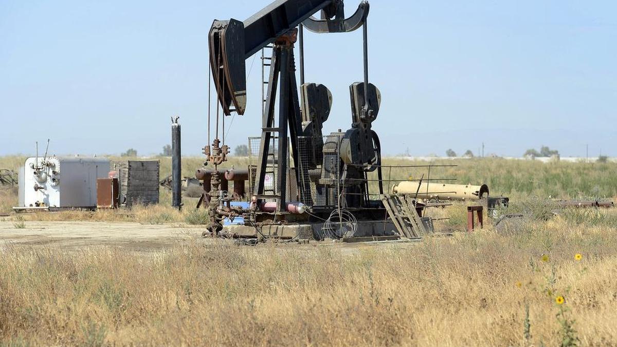 An oil pump jack is seen in a field just outside of Riverdale Thursday, July 30, 2015. Scattered throughout the agricultural fields and western foothills of Fresno County are thousands of oil and gas wells producing millions of barrels of crude oil and billions of cubic feet of gas each year.
