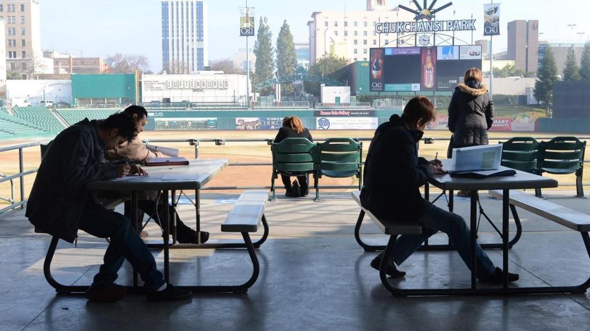 People fill out applications for Chukchansi Park jobs in January 2013.