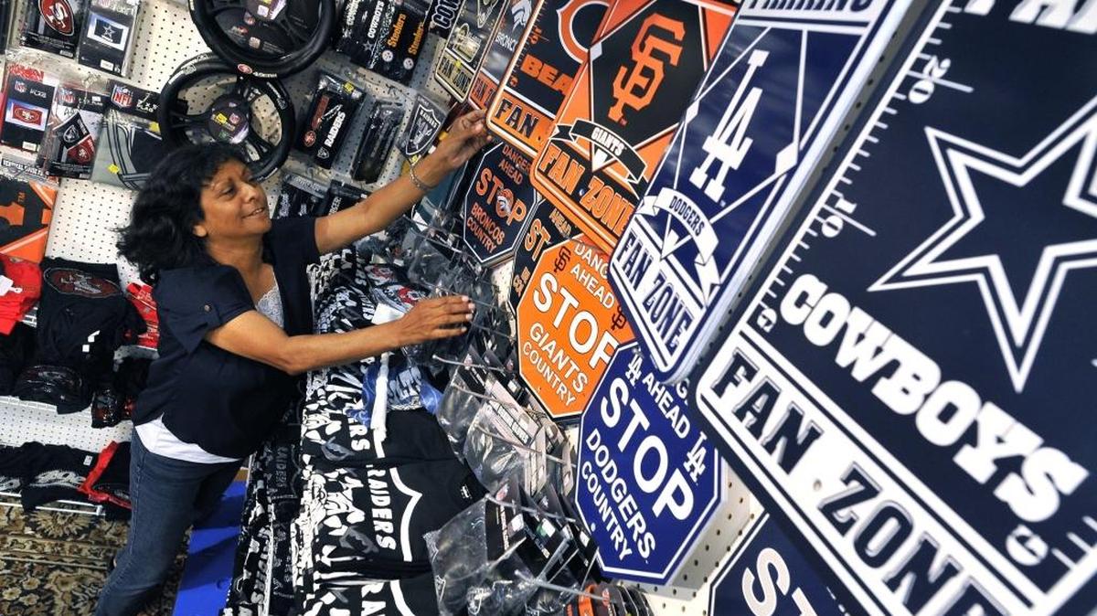 
Mary Palacio of Fresno’s Kool Designs shows the vast array of sports team items for sale at the Big Fresno Fair. 
