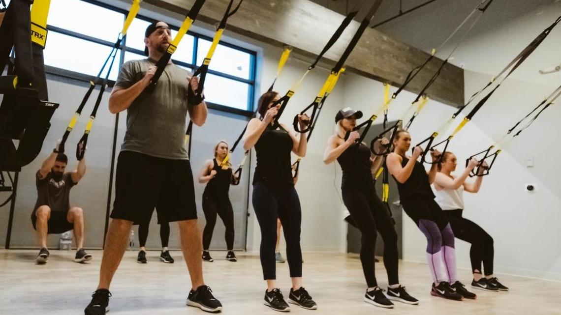 In addition to indoor cycling, RIDE54 offers TRX-based strength training classes. Using what are essentially resistance bands, an instructor can lead 18 people in a class exercise that uses their own body weight.
