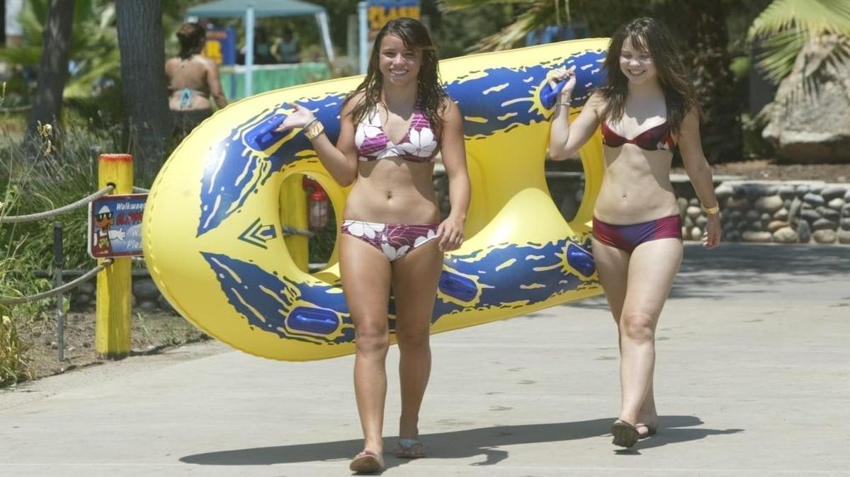 Jaimie Lugo, 15, left, and Marie Houx, 16, carry a large raft during a 2006 visit to Wild Water Adventures.