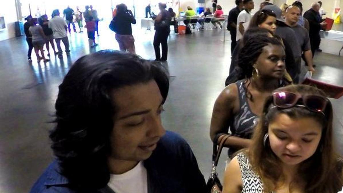 Andrew Perez, left, and sisters Guadalupe and Perla Cuevas chat as they wait to turn in applications during the Big Fresno Fair’s 2015 job fair.