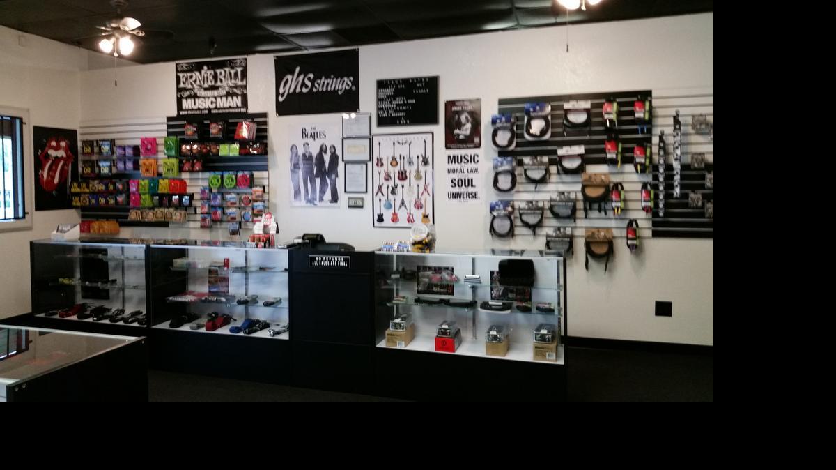 
Guitar parts, straps, cases, strings and other music items are displayed at JT’s Music Store.
