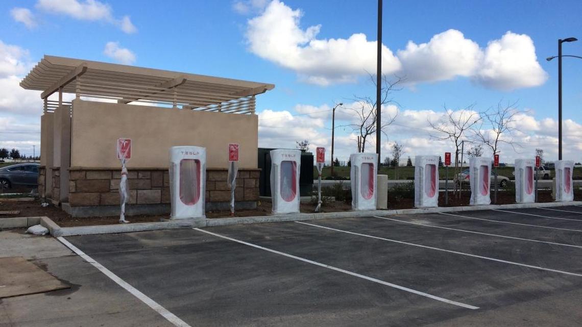 Tesla Supercharger stations are wrapped in plastic before their debut at The Marketplace at El Paseo shopping center. Owners of Tesla electric cars can recharge their cars in 30 minutes to travel up to 170 miles.