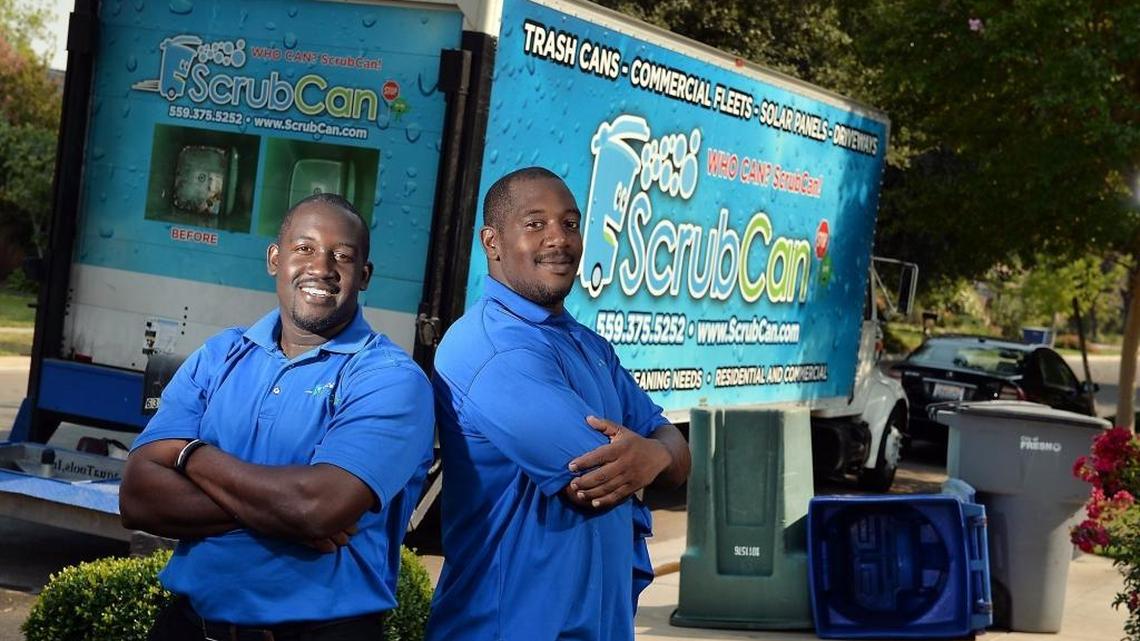 ScrubCan owner Corey Jackson, left, and his brother Phillip Jackson, 33, both of Fresno, clean out garbage cans using reclaimed water in Fresno. This file photo taken in 2015.