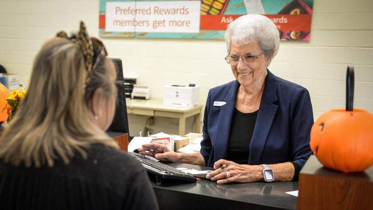 Joanna Ayerza, right, chats with customer Mary Cottrell of Kerman at the Bank of America Branch in Kerman on Thursday, Oct. 31, 2019 (before the coronavirus pandemic emerged). Bank of America is one of the lenders able to process stimulus loan requests, but it’s facing a high volume of business applications.