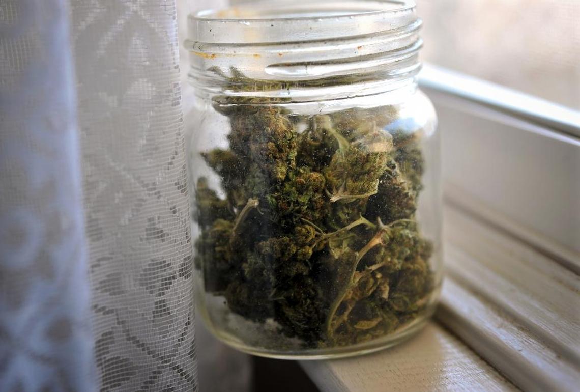 A jar on a window sill holds marijuana buds grown for medicinal uses by a Fresno husband and wife in this 2014 file photo. The passage of Proposition 64 in November 2016 not only legalized personal use and possession of marijuana under California law, but also legalized cultivation of up to six plants for personal use. Marijuana, however, remains illegal under federal law.