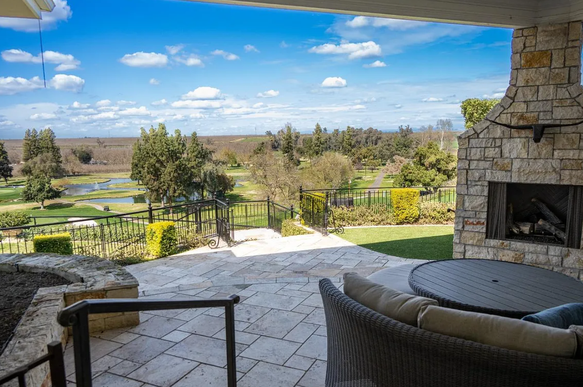 The view from one of the outdoor seating areas that includes a fireplace.