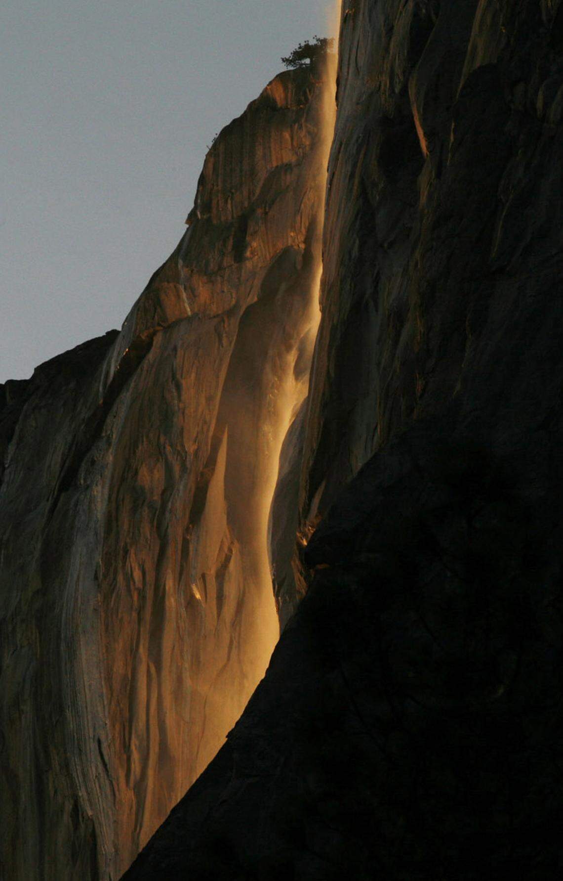 Water from Horsetail Falls is lit by the last light at sundown on Sunday, Feb. 14, 2010, in Yosemite Valley at Yosemite National Park.