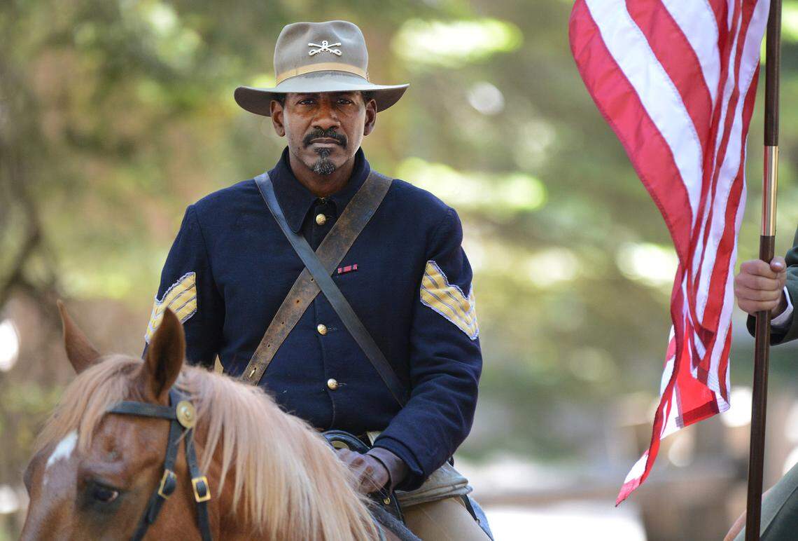 Yosemite National Park ranger Shelton Johnson wears the uniform of a Buffalo Soldier while saddled on his horse during the Yosemite Grant sesquicentennial ceremony at Yosemite National Park's Mariposa Grove Monday, June 30, 2014. 