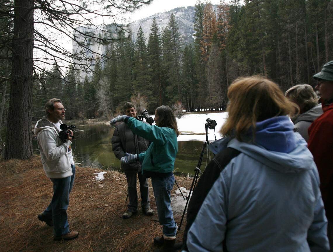 Photographers talk about the history of the firefall as they wait along the Merced River in Yosemite Valley in 2010.
