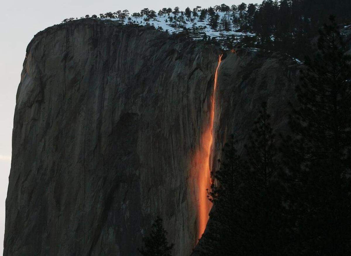 The annual firefall from Horsetail Fall in Yosemite Valley glows after the sun has disappeared below the horizon. 