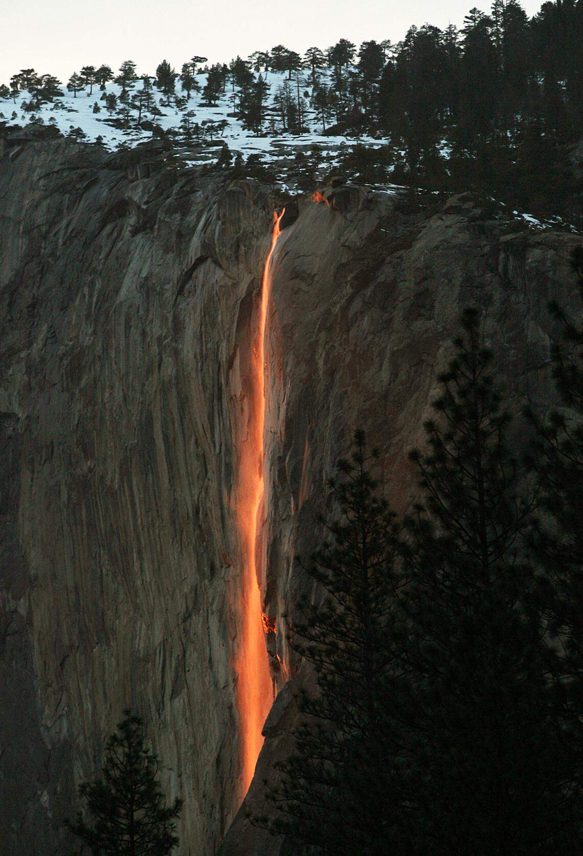 The firefall from Horsetail Falls in Yosemite Valley glows after the sun disappears below the horizon in 2010.