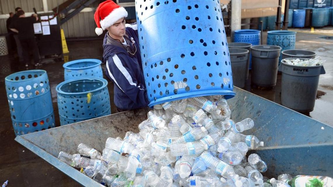 Kevin Bono of Clovis Recycling Center collects plastic bottles at the center in December 2013. The city of Fresno wants to tighten its rules for where recycling centers can operate. But a local judge says a city law goes too far.