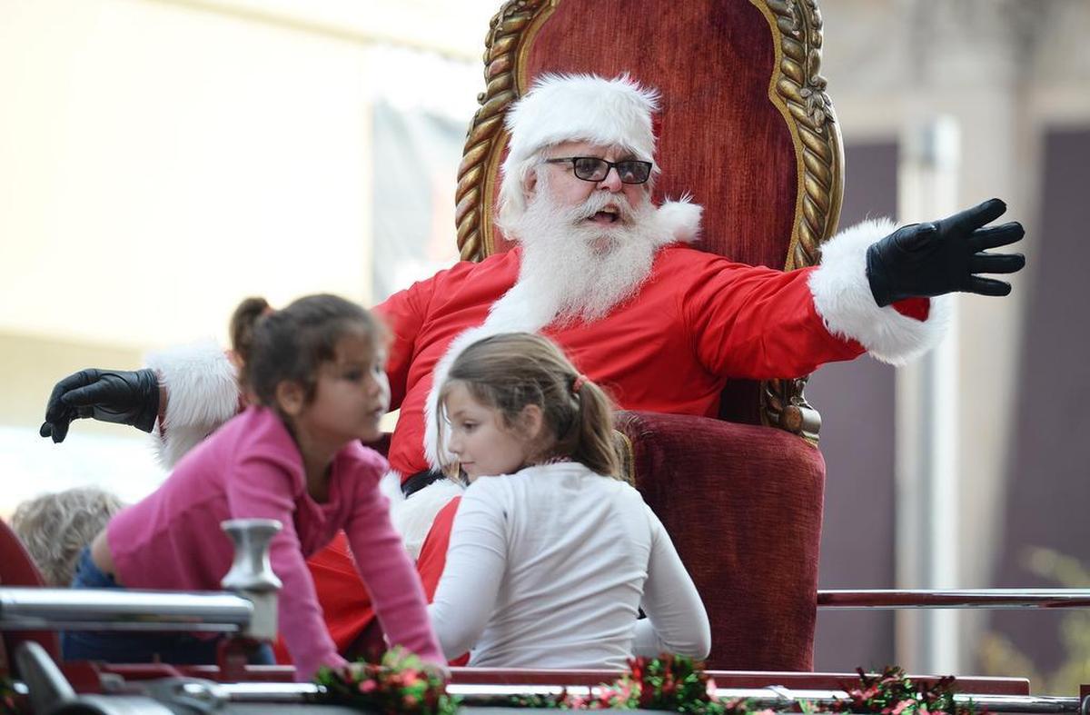 Santa waves while riding with a few friends on a fire truck during the 2017 Downtown Fresno Christmas Parade.