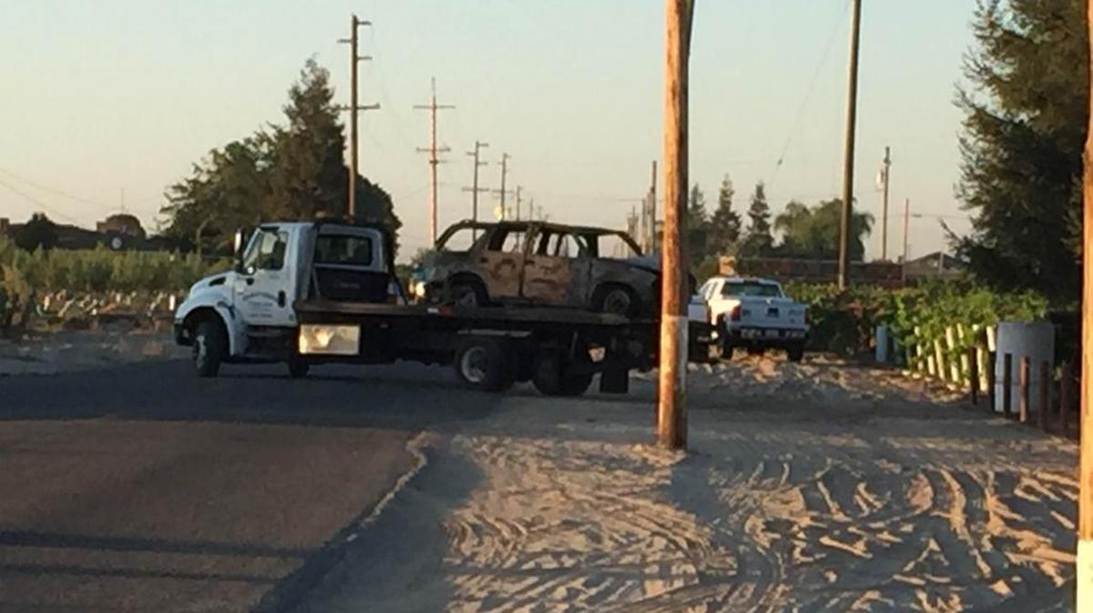 
A car that burst into flames after hitting a power pole is removed from the crash scene on South Cornelia Avenue on Friday.

