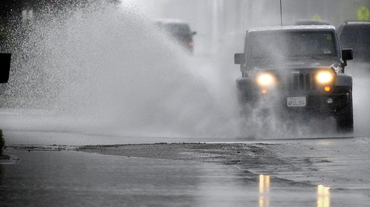 A Jeep sends a plume of rainwater flying on Elm Avenue in Easton, during the storm Monday, Feb. 7, 2016.