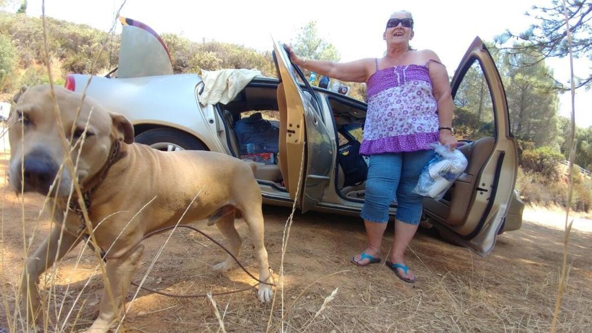 Debbie Blue and her dog Rusty no longer have a place to live after the Detwiler Fire devoured her trailer home near Mariposa on Tuesday.