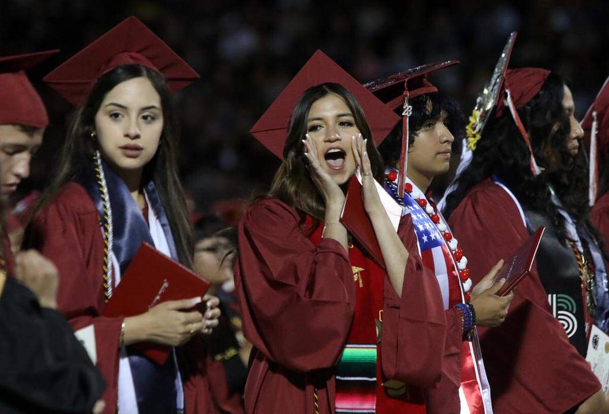A graduate cheers during the first graduation ceremony for Matilda Torres High School at Madera Memorial Stadium on June 10, 2023.