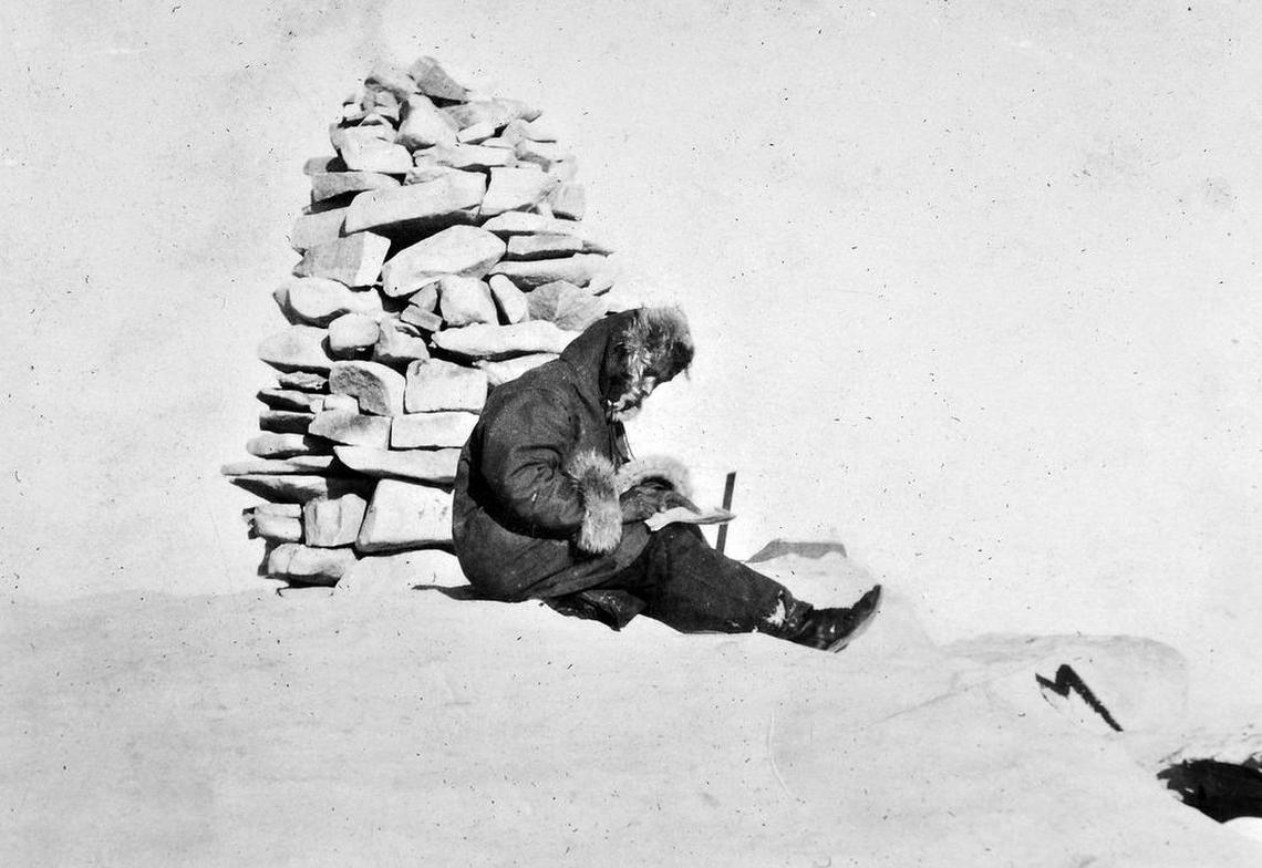 Orland Bartholomew, the first known person to do a solo winter ascent of Mt. Whitney, writes in his journal while sitting at the cairn – a marker of piled stones – at the 14,505-foot summit on Jan. 10, 1929. He took the photo with his camera on a timer.