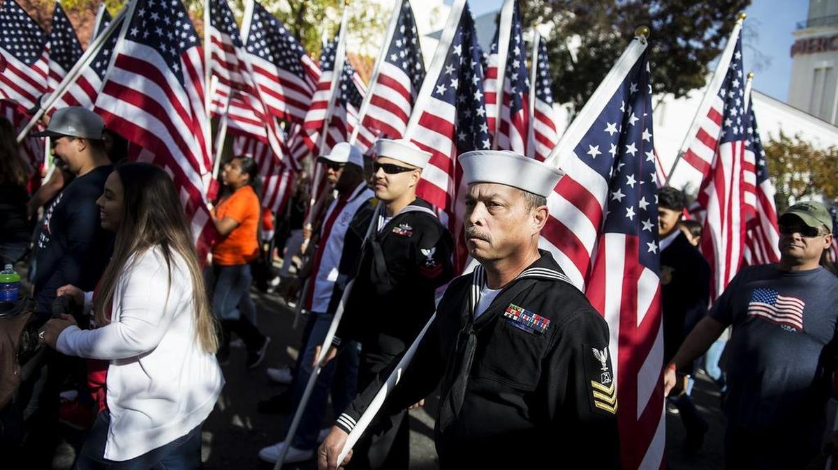 American flags are carried during the 2017 Merced Veterans Day Parade.