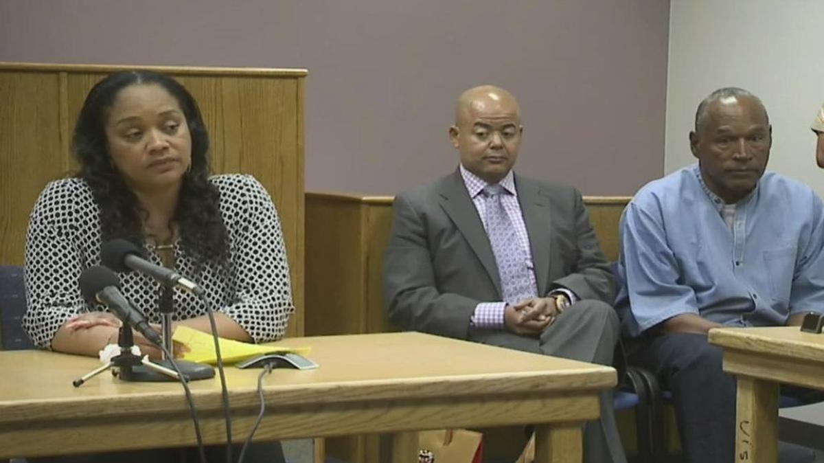 Arnelle Simpson, left, testifies for her father, former NFL football star O.J. Simpson, far right, as attorney, Malcolm LaVergne, center, listens during O.J. Simpson's hearing at the Lovelock Correctional Center in Lovelock, Nev., on Thursday, July 20, 2017. Simpson was convicted in 2008 of enlisting some men he barely knew, including two who had guns, to retrieve from two sports collectibles sellers some items that Simpson said were stolen from him a decade earlier.