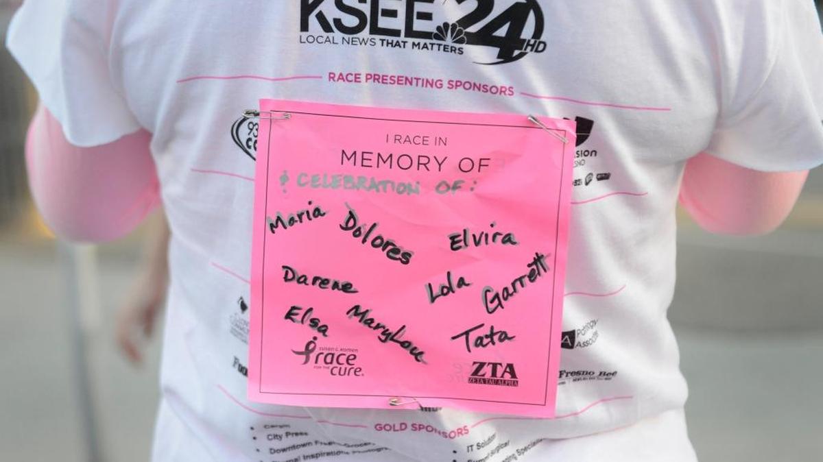 Cindy Rodriquez of Fresno wears a sign on her shirt showing the names of family and friends she is running in memory of before the start of the 2015 5K at the Susan G. Komen Race for the Cure at Fresno State. The event raises funds and awareness for the breast cancer movement, celebrates breast cancer survivorship and honors those who have lost their battle with the disease.