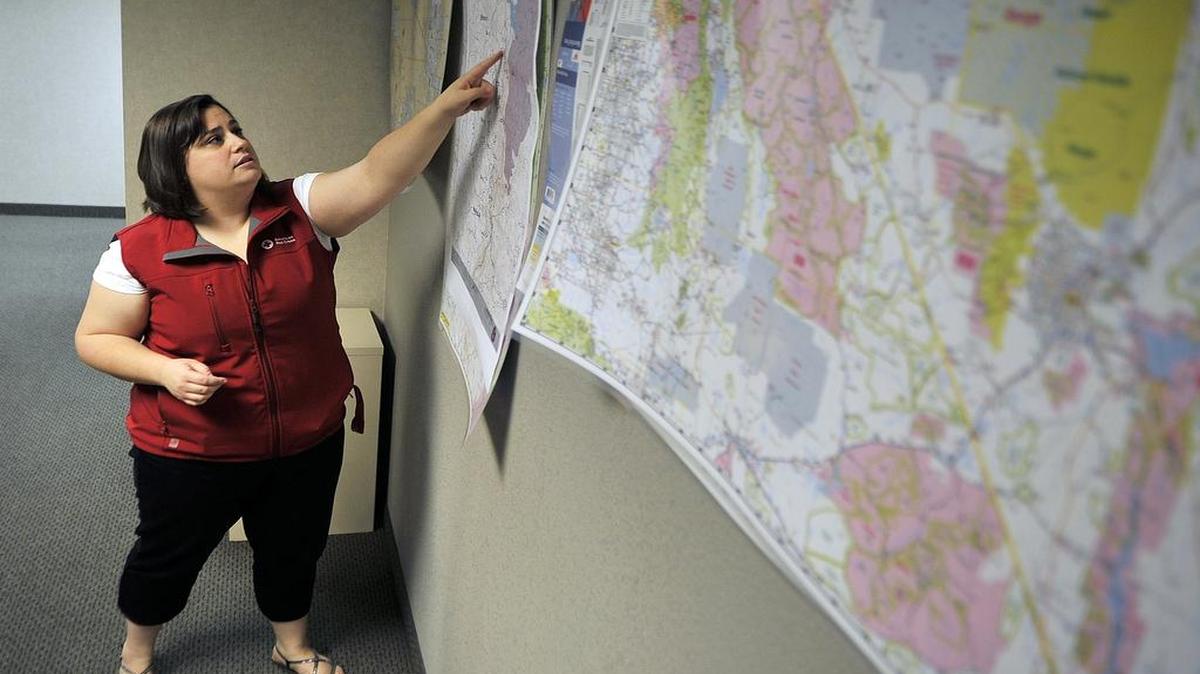 
American Red Cross Central Valley's director of communications Jessica Piffero shows a fire map on a wall at the agency's office. .

