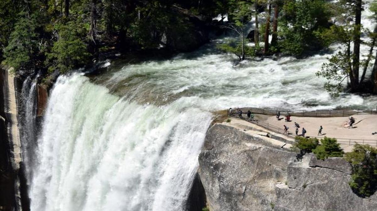 Yosemite’s Vernal Falls is a torrent of water, with onlookers dwarfed by the spectacle, upper right, as they look on from the observation deck Tuesday afternoon.