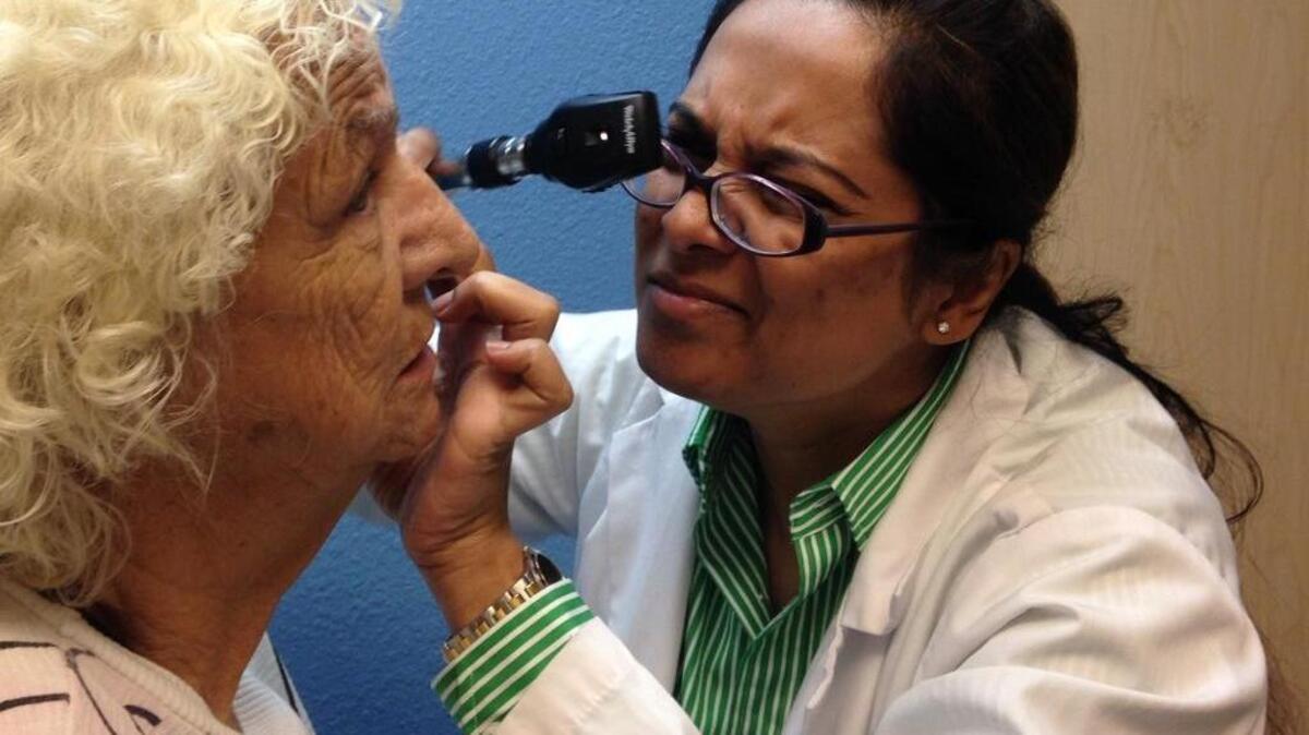 Tahmina Rahman, a resident in the Sierra Vista Family Medicine program, examines Helen Phillips in July 2014. The program, which opened three years ago at a Clinica Sierra Vista center in downtown Fresno, will graduate its last class of residents at the end of June 2017, potentially leaving a gap in the central San Joaquin Valley in homegrown doctors.
